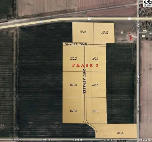 Aerial view of a rural land development with numbered lots, roads, and surrounding fields.