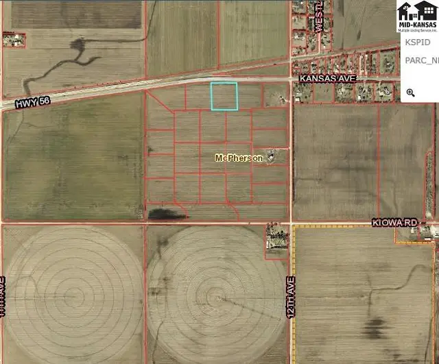 Aerial view of subdivided farmland with irrigation circles and highway access.