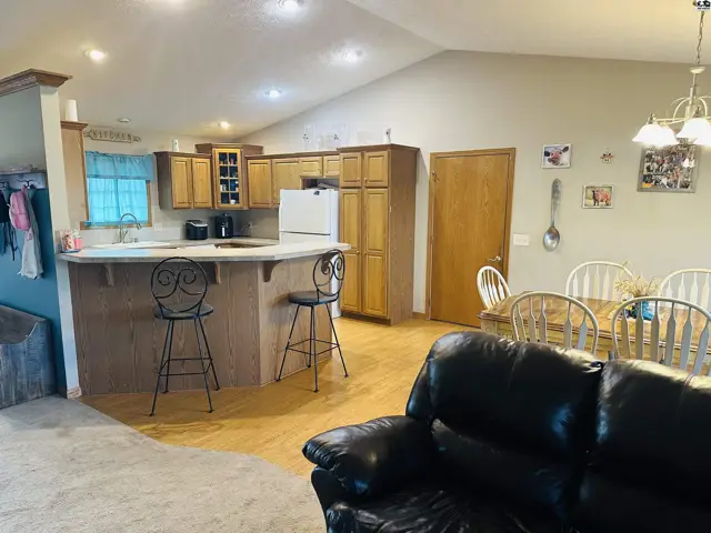 Spacious kitchen with ample cabinetry, breakfast bar, and adjacent dining area.
