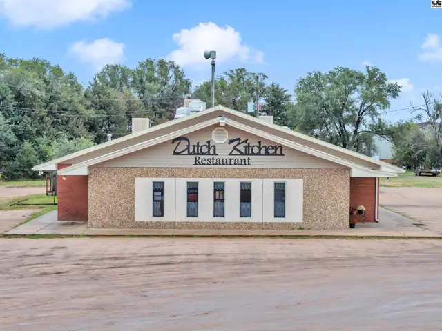 Commercial building exterior with "Dutch Kitchen Restaurant" signage, brick and stone facade, and large windows.