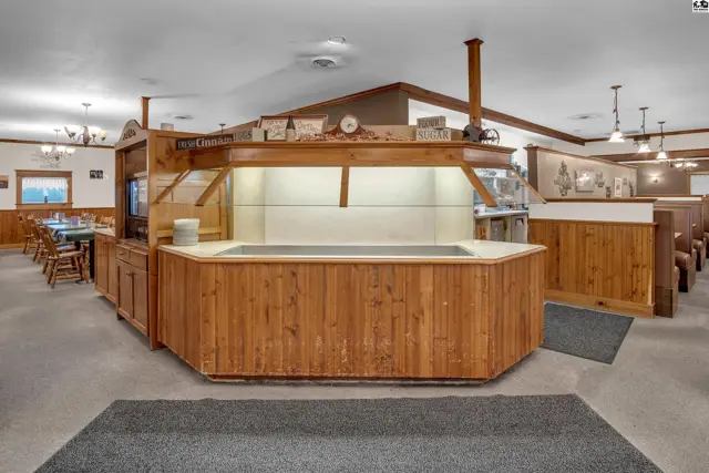 Warm wood accents and booths define this spacious dining area with a central service counter.