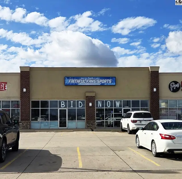 Commercial storefront with large windows, brick accents, and a prominent "Faithful Fans Sports" sign.