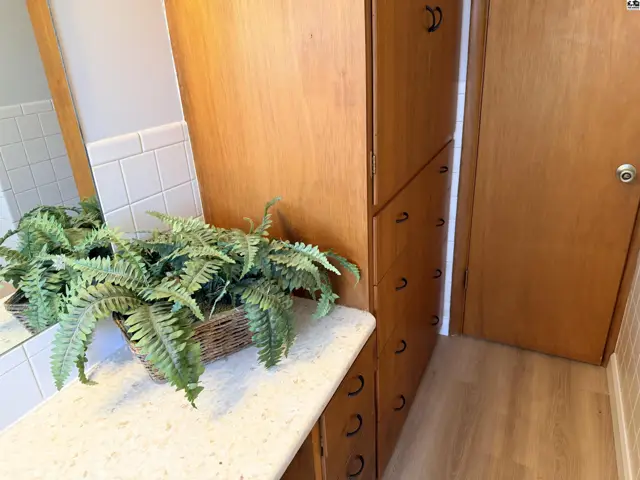 Light wood cabinetry and a speckled countertop are featured in this room.