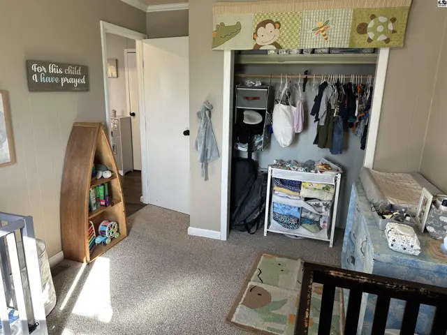 Nursery with cribs, changing table, boat-shaped bookshelf, and a closet filled with baby clothes.