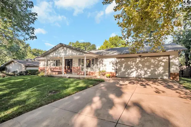 Spacious ranch home with brick accents, a covered front porch, and attached two-car garage.