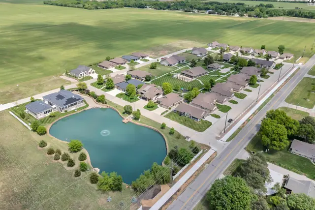 This property features a large pond with a fountain and surrounding homes.