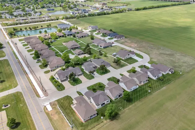 This aerial view shows a suburban neighborhood with single-family homes and manicured lawns.