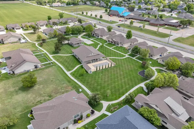 This property features multiple buildings surrounded by manicured lawns and paved walkways.