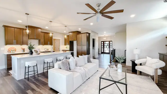 Spacious open-concept living area with a modern kitchen, island, and comfortable seating.
