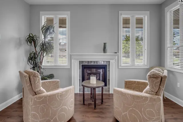 This room features a fireplace, two armchairs, and a small round table.