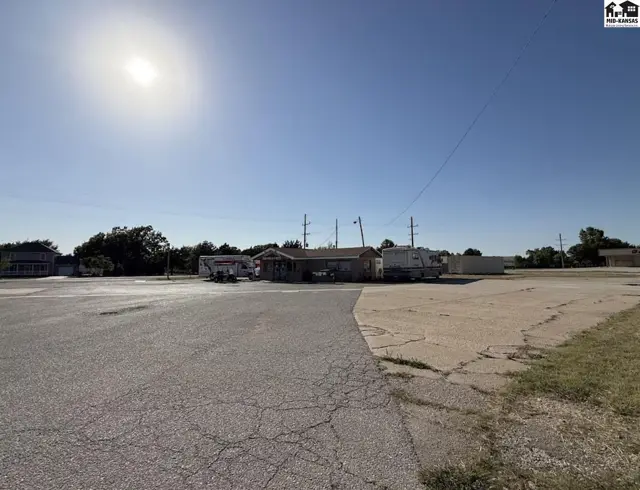 Commercial building with RVs parked outside, set against a clear blue sky.