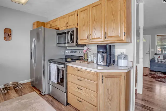 Kitchen with stainless steel appliances, light wood cabinets, and laminate countertops.