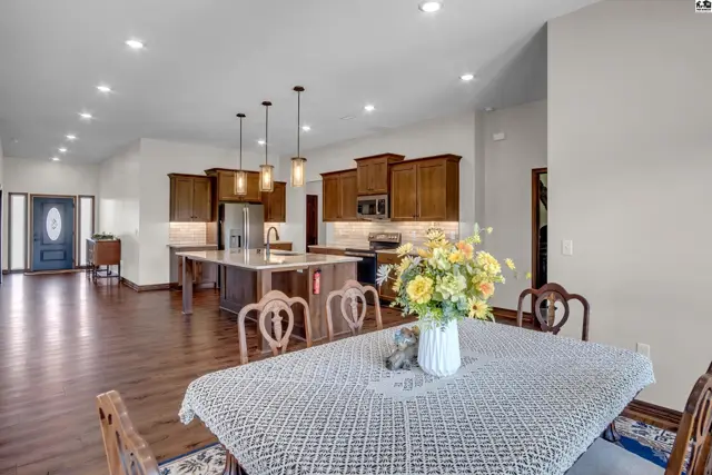 Spacious open-concept living area with a large kitchen island and dining table.