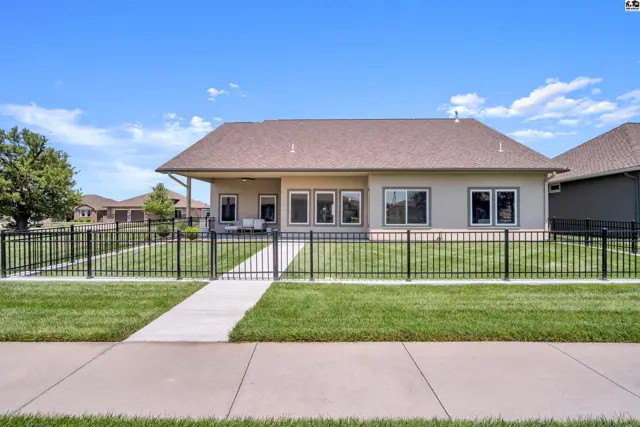 This single-story home features a covered patio and a fenced backyard.