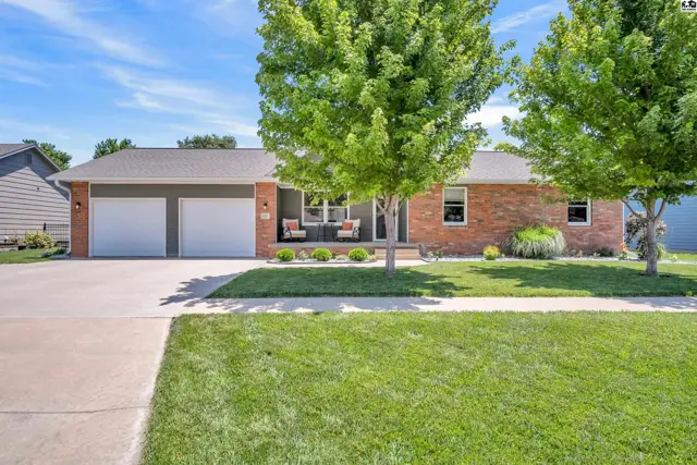 Brick and siding ranch home with a two-car garage and inviting front porch.