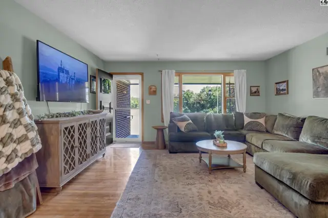 Spacious living room with a large sectional sofa, coffee table, and entertainment console.