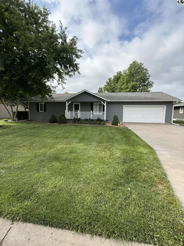 Gray ranch home with white trim, a covered porch, and an attached two-car garage.