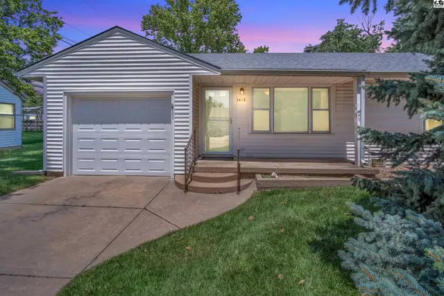Exterior of a white vinyl-sided ranch home with a single-car garage and a covered front porch.