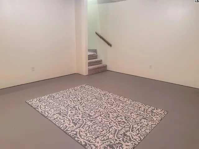 Basement family room or bonus room with view of stairway.
