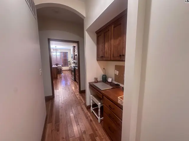 Hallway from garage looking toward kitchen. 9' ceilings and 8' arched doorways.