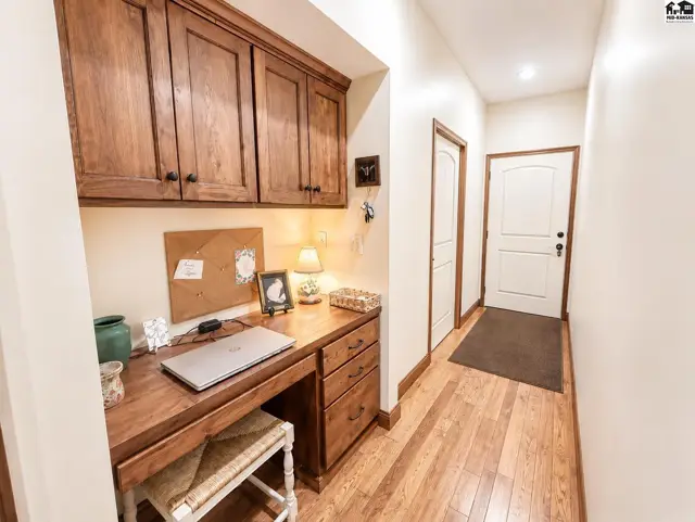 Hallway to laundry room and garage. Includes built in desk and custom cabinetry.