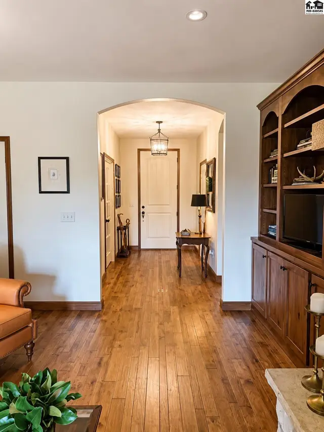 Foyer w/ coat closet, wood floors, 8' solid wood door, French doors lead to office or formal dining.