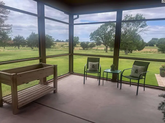 Wraparound screened in porch looking out to south and west of property.