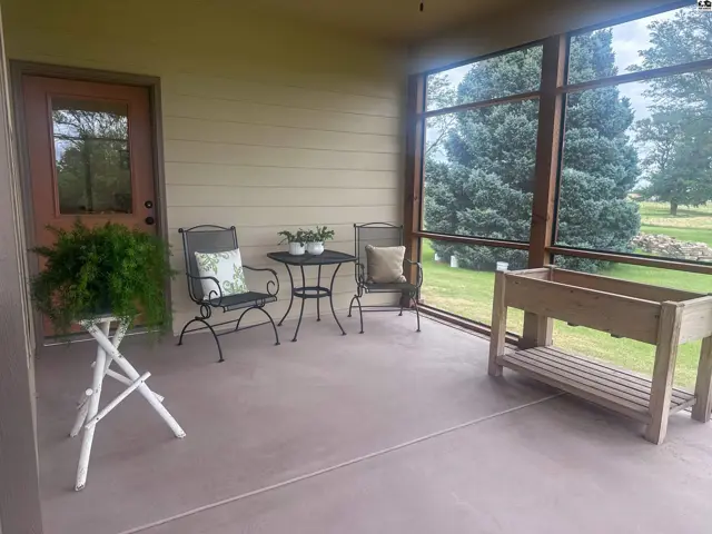 Wraparound screened in porch with view of door to SW bedroom.