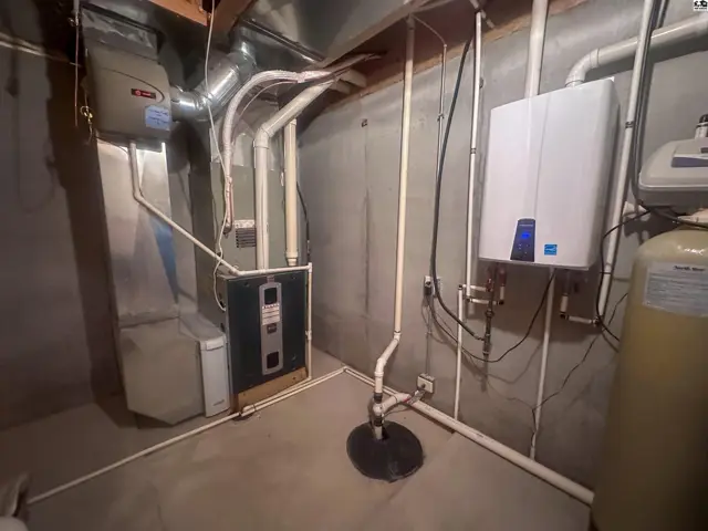 Basement utility room with view of HVAC system  and tankless water heater.