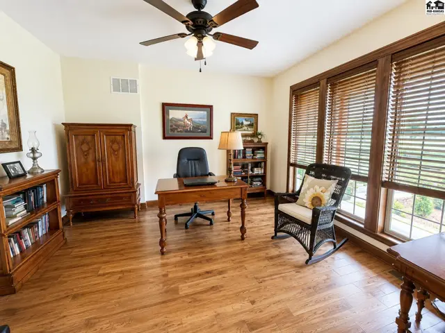 Office offers wood floors, tall east windows, double French doors to foyer & door to living room.