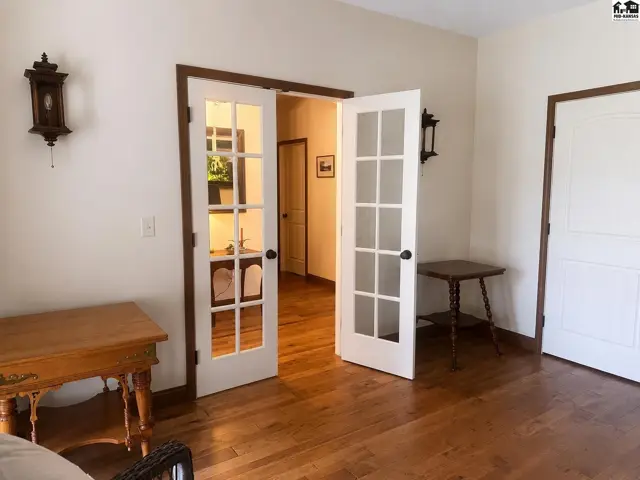view of French doors to foyer and door to living room.