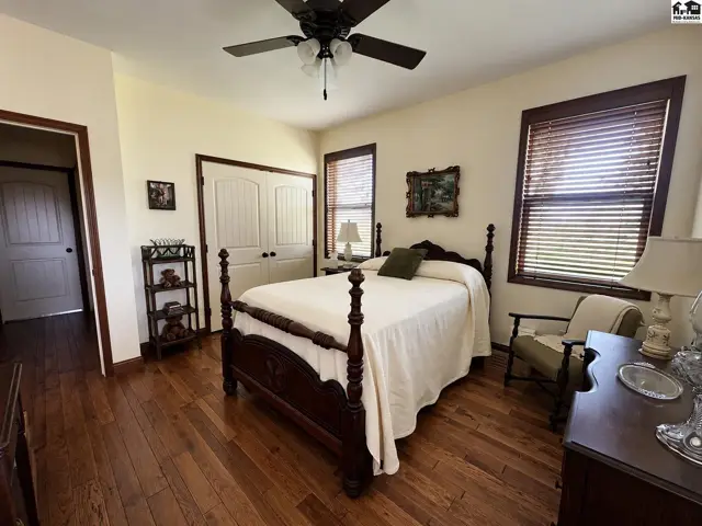 View of double door closet and wood floors in southwest bedroom