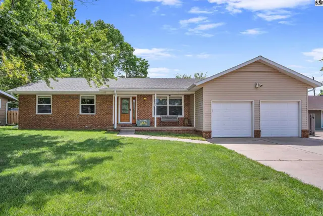 Brick and tan siding ranch home with a covered porch and attached two-car garage.