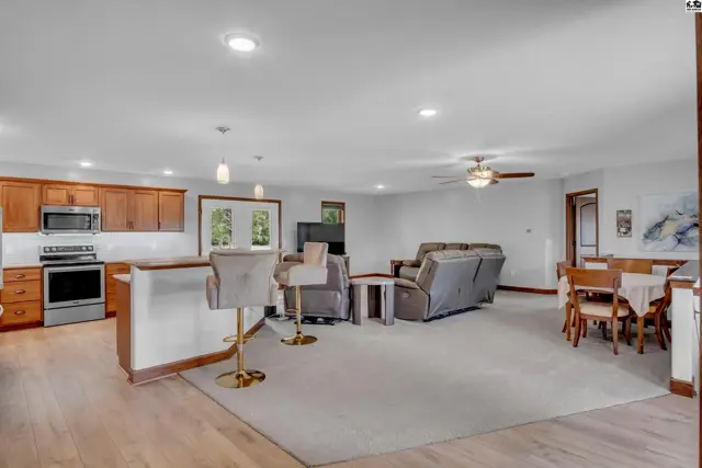 Spacious open-concept living area with a modern kitchen, comfortable seating, and a dining nook.