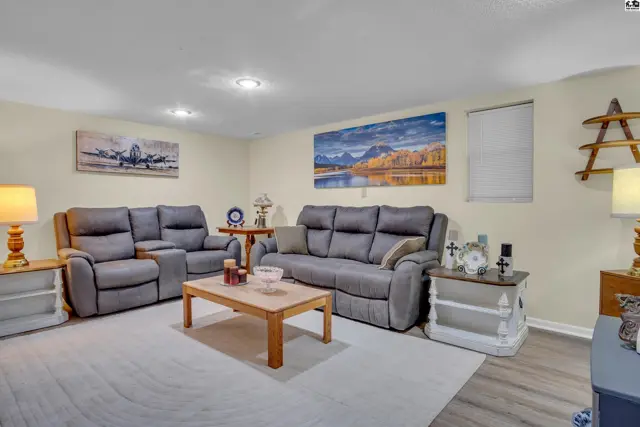 Spacious living room with plush seating, a coffee table, and decorative wall art.