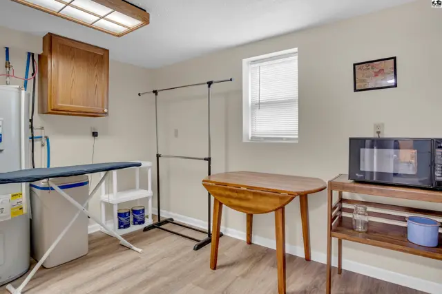 This room features a laundry area, a folding table, and a microwave.