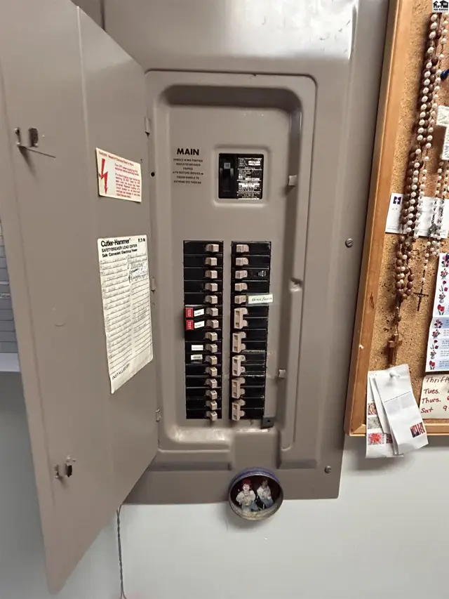 This electrical panel features a metal enclosure with multiple circuit breakers.