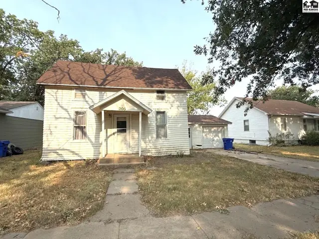 This two-story house features a covered front porch and attached garage.