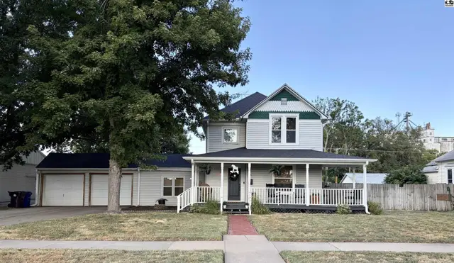 This two-story home features a wraparound porch and an attached two-car garage.