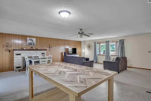 Spacious living area with a fireplace, dining table, and seating arrangements.