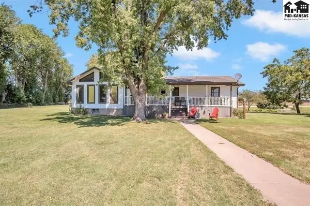 This single-story home features a covered porch and large windows.