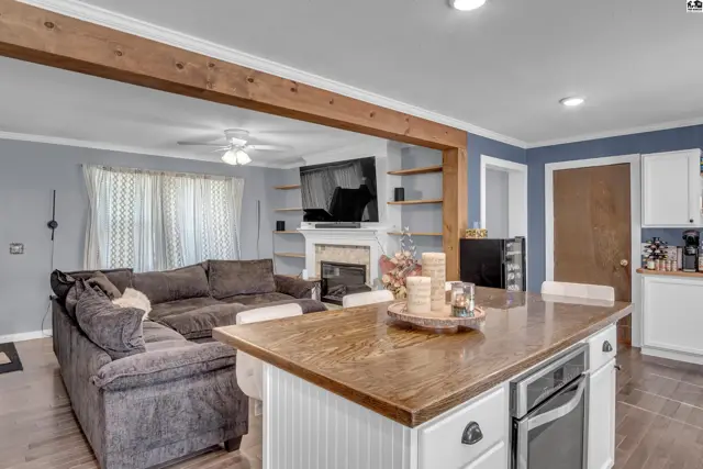 Spacious living area with a large sectional sofa, fireplace, and kitchen island.