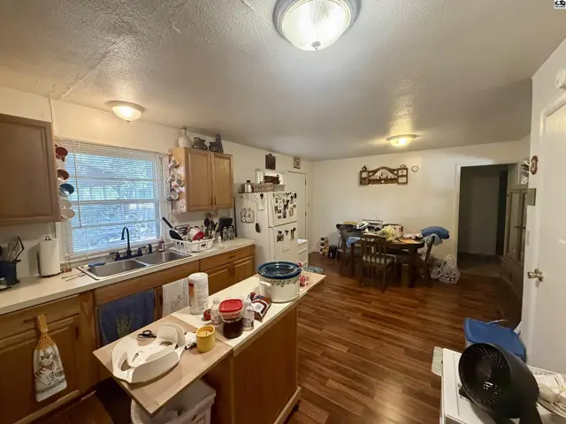 Spacious kitchen with wood cabinets, laminate countertops, and a dining area.