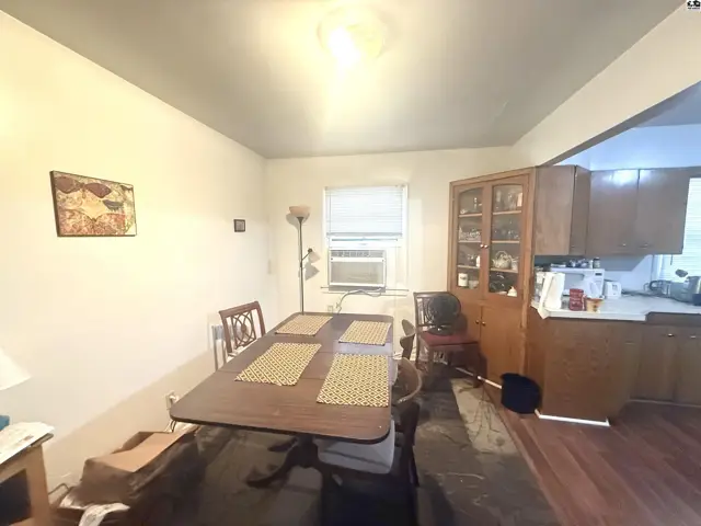Dining area with a table, chairs, and a built-in cabinet adjacent to the kitchen.