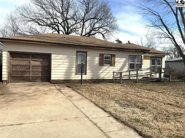 This single-story home features a detached garage and a sloped ramp to the entrance.