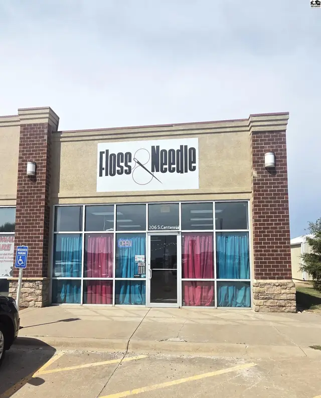 Commercial building with large glass windows and brick accents.