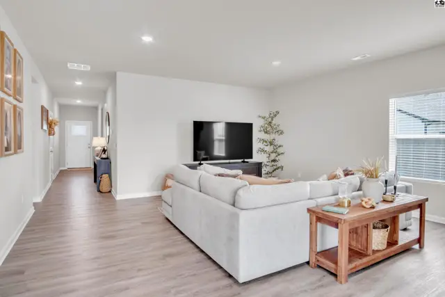 Spacious living area with a large sectional sofa and wood-toned console table.