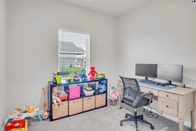 This room features a desk, chair, shelving unit, and a window with blinds.