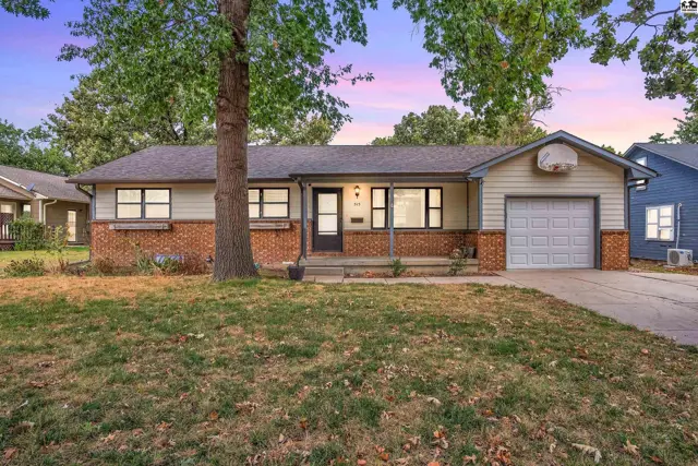 This single-story home features a brick and siding exterior, a covered porch, and an attached garage.