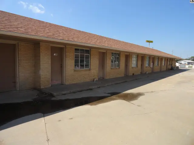 This single-story building features a brick exterior and a long, covered walkway.